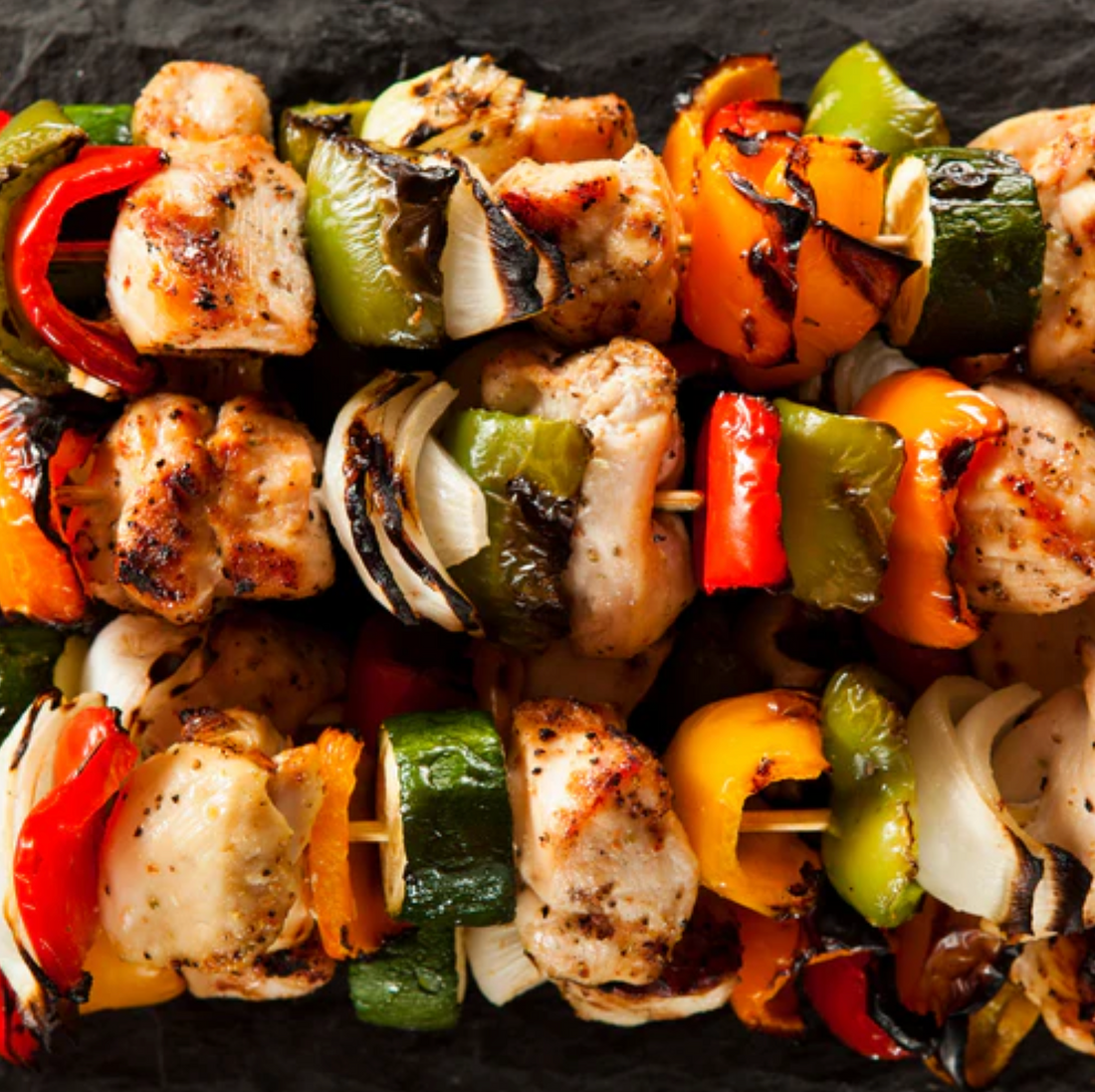 3 grilled kabobs with chicken and fresh veggies