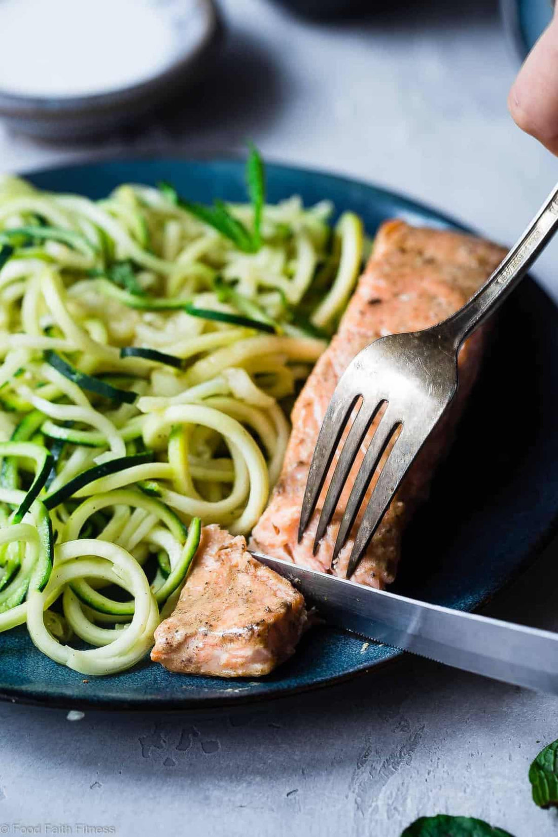 Curry salmon fillet on a pile of zucchini noodles