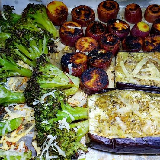 Shrimp stuffed eggplant with creole seasonings on a pan with roasted broccoli