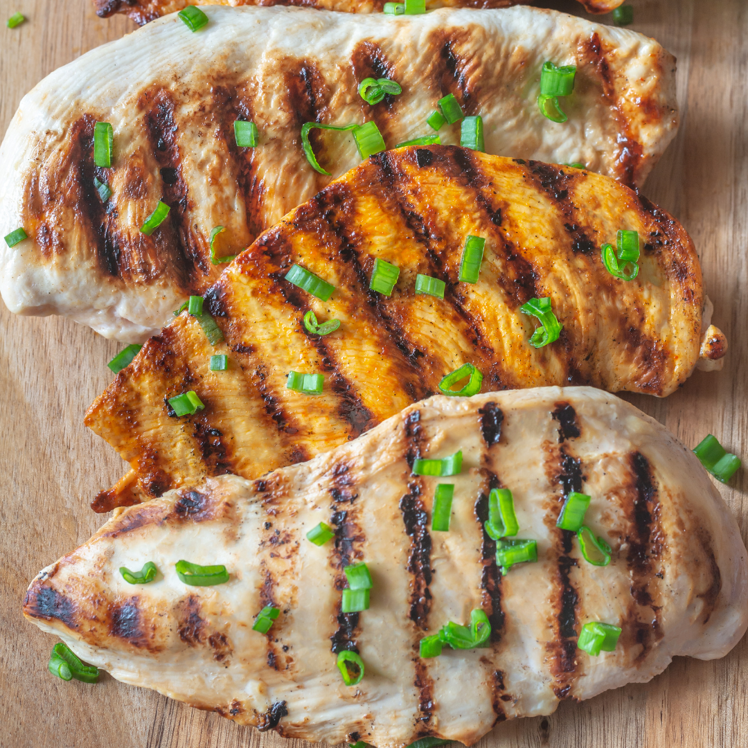 3 Grilled Chicken Breasts topped with circular cut green onions.